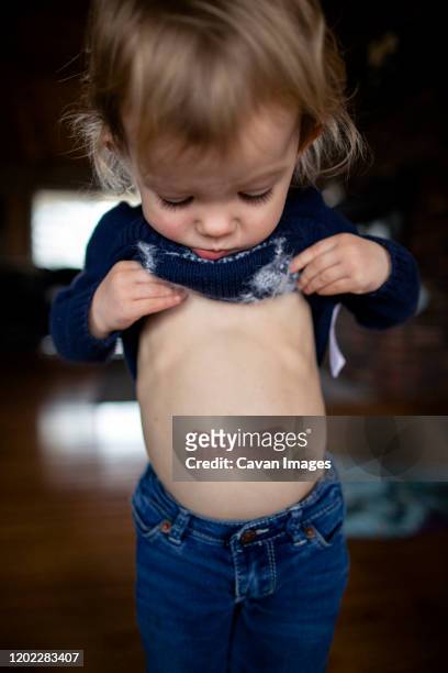 toddler girl with bandaid on stomach - stomach child stock pictures, royalty-free photos & images