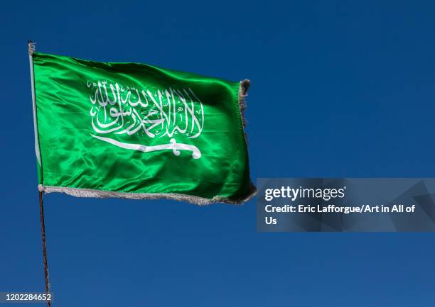 Saudi arabian flag in the wind against clear sky, Al Madinah Province, Yanbu, Saudi Arabia on December 26, 2019 in Yanbu, Saudi Arabia.
