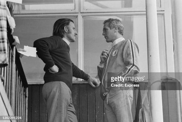 British Formula One racing driver Graham Hill chatting to American actor Paul Newman at the Universal Motor Racing Club school at Brands Hatch motor...