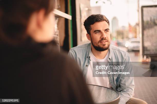 couple sitting at sidewalk cafe - soul searching stock pictures, royalty-free photos & images