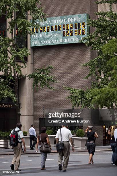 The National Debt Clock, a billboard-size digital display showing the increasing US debt, is seen on the corner of Sixth Avenue and West 44th Street...