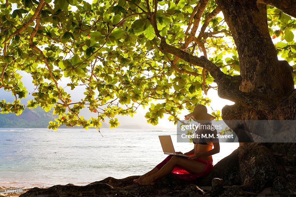 Woman working under tree