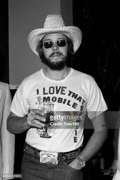 Hank Williams Jr. Enjoys a drink before performing for a record industry audience at Stouffer's Hotel on May 26, 1977 in Atlanta, Georgia.