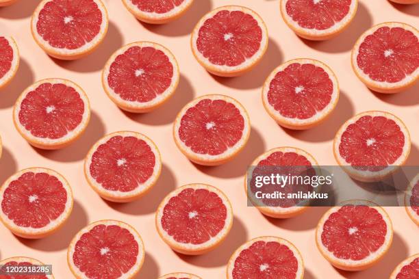 grapefruit pattern on yellow background - grapefruit stock pictures, royalty-free photos & images