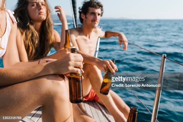 friends enjoying beer on sailboat, italy - beer flowing stock pictures, royalty-free photos & images
