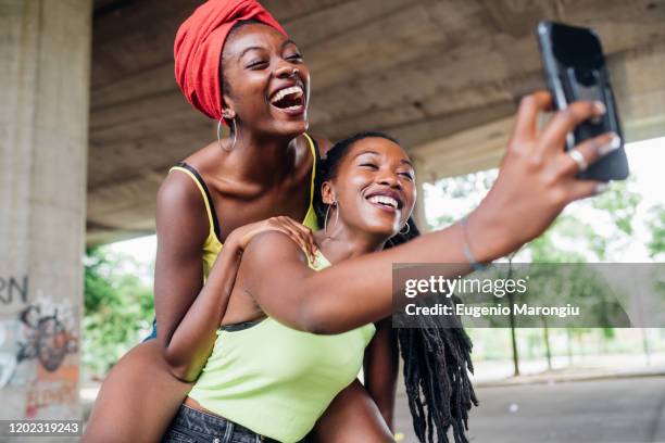 friends taking selfie in city - girl power graffitti stock pictures, royalty-free photos & images