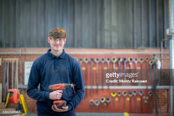 portrait of apprentice timber mould maker in steelworks - stage set stockfoto's en -beelden