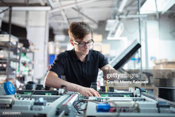 apprentice electronics engineer in electronics assembly factory - it apprentice stock pictures, royalty-free photos & images