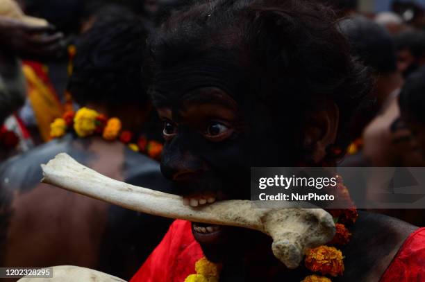 An artist performs with a human skull and bones during the procession of Maha Shivaratri festival , celebrated in the reverence of Hindu God Shiva ,...