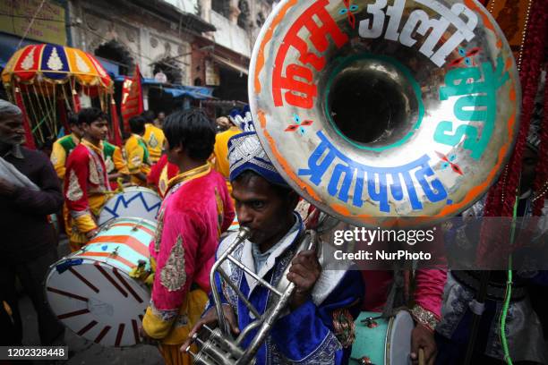 Musicians of a local brass band company play music during the procession of Maha Shivaratri festival , celebrated in the reverence of Hindu God Shiva...