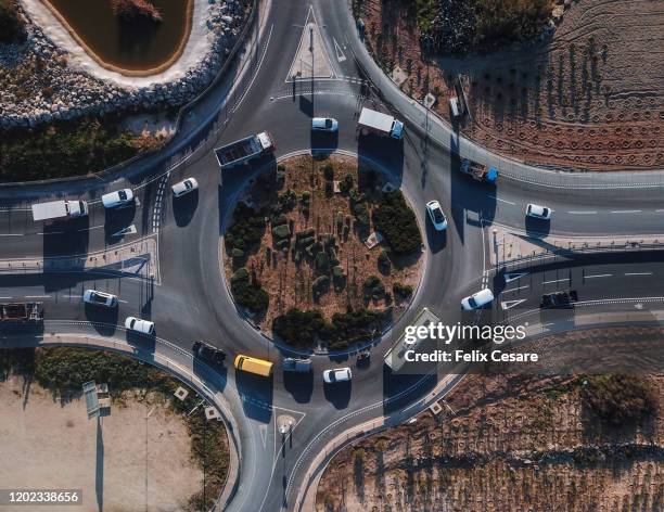 aerial view of cars turning around a circular intersection - malta aerial stock pictures, royalty-free photos & images