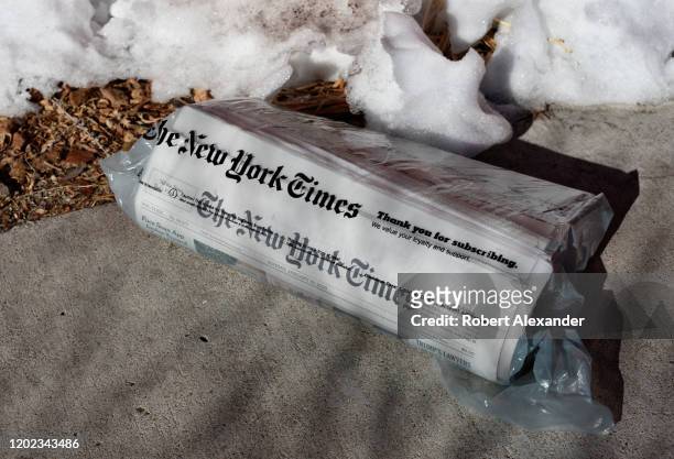 Home-delivered copy of The New York Times on a driveway in Santa Fe, New Mexico.