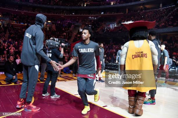 John Henson celebrates with Darius Garland of the Cleveland Cavaliers during player introductions prior to the game against the Chicago Bulls at...
