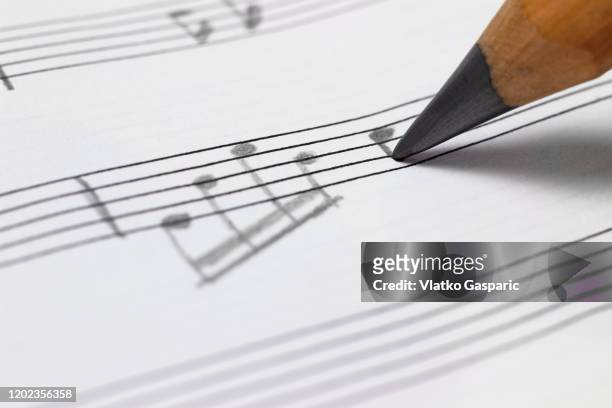 close-up of writing a musical note - writing instrument bildbanksfoton och bilder