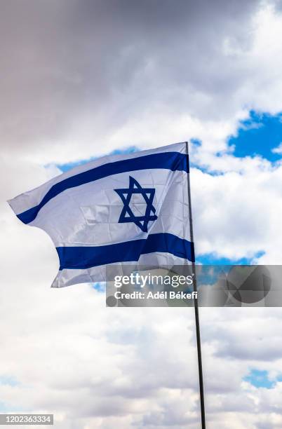 israeli national flag waving in the wind - israel flag stock pictures, royalty-free photos & images