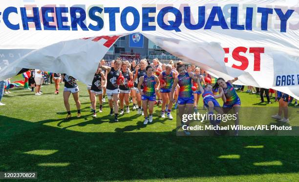 Players prepare to run through a joint banner during the 2020 AFLW Round 03 match between the Western Bulldogs and the Carlton Blues at VU Whitten...