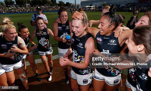 Blues players sing the team song during the 2020 AFLW Round 03 match between the Western Bulldogs and the Carlton Blues at VU Whitten Oval on...