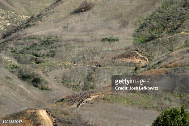 Emergency personnel work at the helicopter crash site that claimed the life of former NBA great Kobe Bryant on January 27, 2020 in Calabasas,...