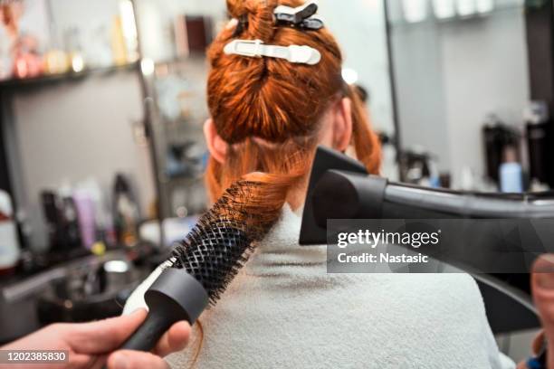 young woman at hairdresser ,hair drying making curls - vanguardista imagens e fotografias de stock