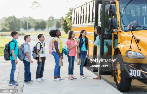 middle school students, teacher boarding a bus - field trip stock pictures, royalty-free photos & images