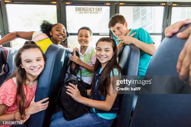 multi-ethnic junior high students riding school bus - play bus stock pictures, royalty-free photos & images