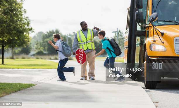 middle school students exit bus, boy with down syndrome - crossing guard stock pictures, royalty-free photos & images