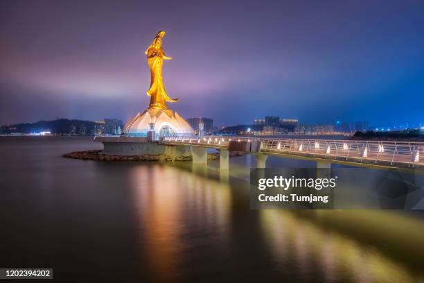 the statue of guanyin (kun iam) temple and city, bridge on night in macau, china. - macao fotografías e imágenes de stock