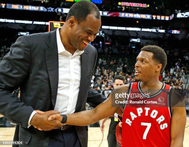 Kyle Lowry of the Toronto Raptors is greeted by former San Antonio Spurs player David Robinson at AT&T Center on January 26, 2020 in San Antonio,...
