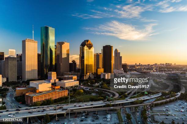 houston downtown aerial en sunset, angled view with highway - skyline fotografías e imágenes de stock