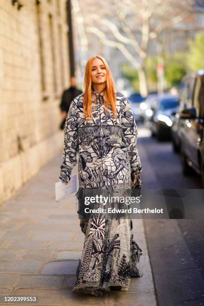 Charlotte Groeneveld wears a navy-blue and white wax pattern fringed jacket, a gathered black and white wax long dress, outside Dior, during Paris...