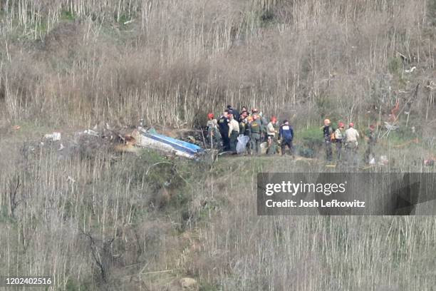 Emergency personnel work at the helicopter crash site that claimed the life of former NBA great Kobe Bryant on January 27, 2020 in Calabasas,...