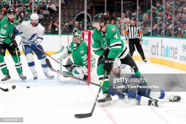 Tyler Johnson of the Tampa Bay Lightning collides with Miro Heiskanen of the Dallas Stars in the second period at American Airlines Center on January...