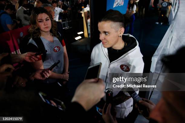 Offensive assistant coach Katie Sowers of the San Francisco 49ers speaks to the media during Super Bowl Opening Night presented by BOLT24 at Marlins...