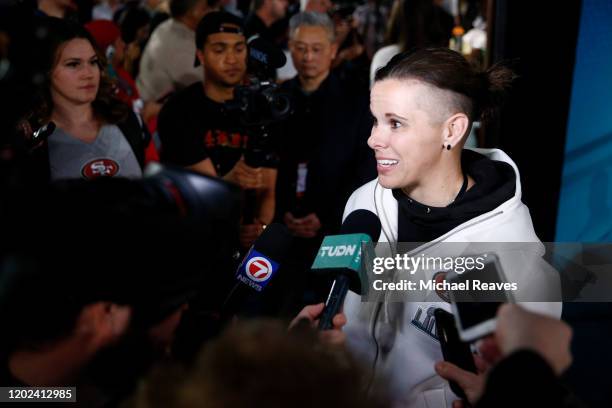 Offensive assistant coach Katie Sowers of the San Francisco 49ers speaks to the media during Super Bowl Opening Night presented by BOLT24 at Marlins...