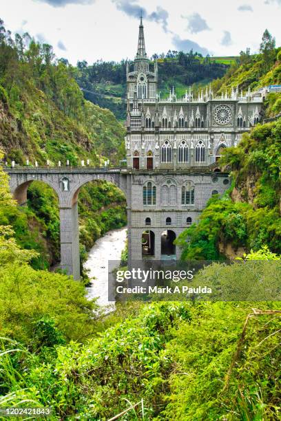 lush green tropical landscape scene with las lajas sanctuary in background - narino stock pictures, royalty-free photos & images