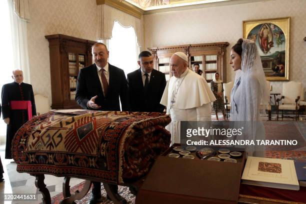 Pope Francis exchanges gifts with Azerbaijan President Ilham Aliyev and his wife Mehriban Aliyeva during a private audience at the Vatican on...