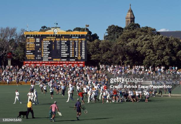 The players are pursued from the field by England fans after England win the 4th Test match between Australia and England by 106 runs at the Adelaide...