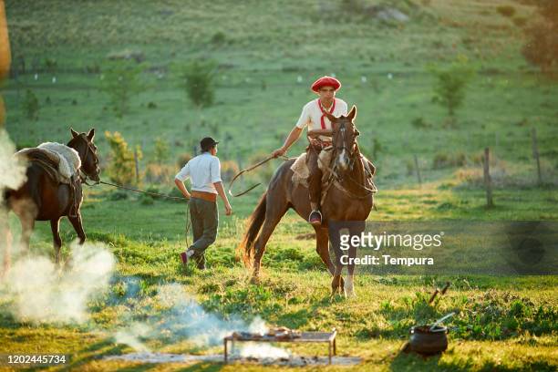 horse riding after an argentinian barbecue. - argentina stock pictures, royalty-free photos & images