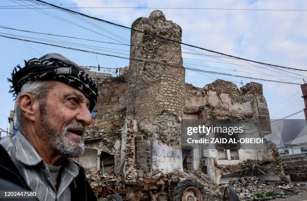 An Iraqi man looks on as he walks past the damaged Umayyad mosque in the old town area of Iraq's northern city of Mosul, on February 21, 2020.