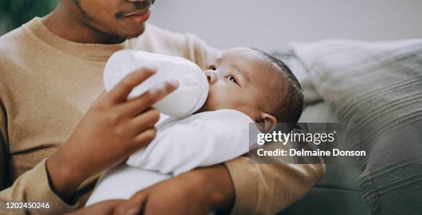 my boy deserves the best start in life - father and baby stock pictures, royalty-free photos & images