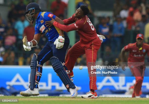 Sri Lankan cricketer Thisara Perera reacts as West Indies cricketer Fabian Allen tries to stop the ball during the 1st One Day International cricket...