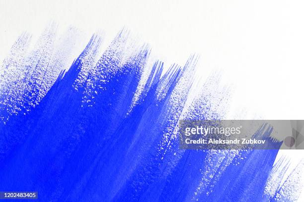 abstract background with streaks of blue paint or watercolor on a white sheet. copy space for text. - hitting ストックフォトと画像