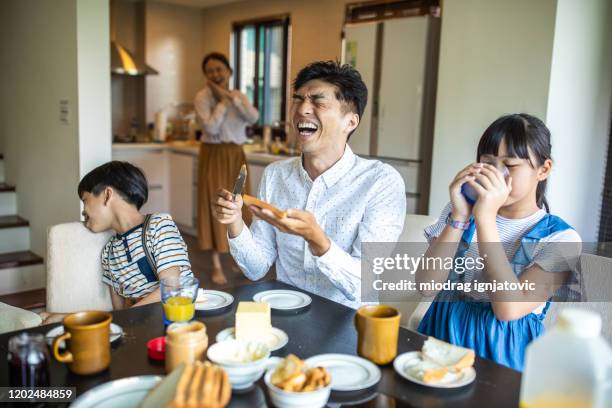 cheerful taiwanese family having breakfast at home - sandwich generation stock pictures, royalty-free photos & images