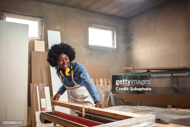 one woman using plank cutter - carpenter stock pictures, royalty-free photos & images