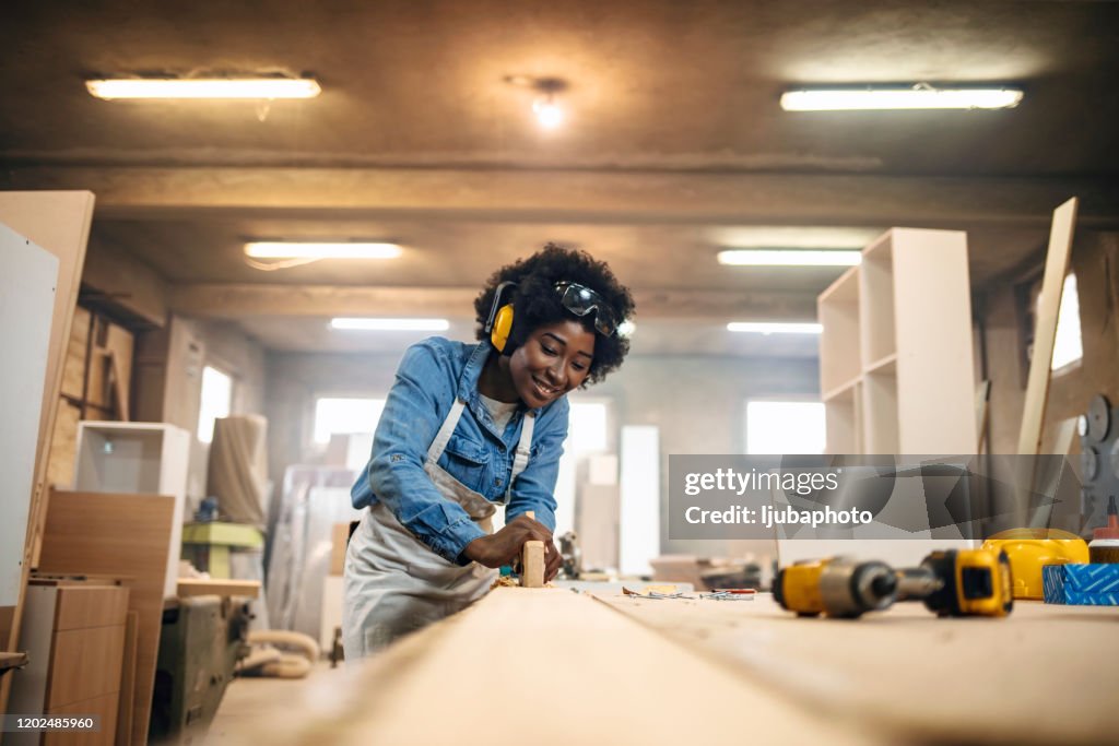 Young woman working as a carpenter