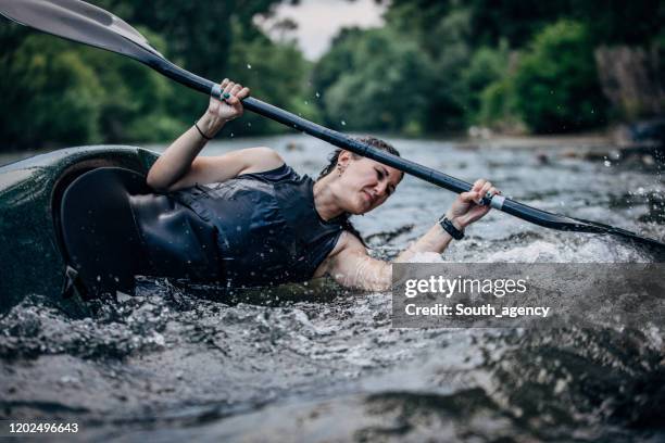 young woman in a kayak sails on a mountain river - kayaking rapids stock pictures, royalty-free photos & images