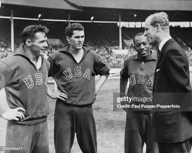 Prince Philip, Duke of Edinburgh chats with American athletes, from left, the hurdlers Clyde Scott and Craig Dixon and sprinter Harrison Dillard at...