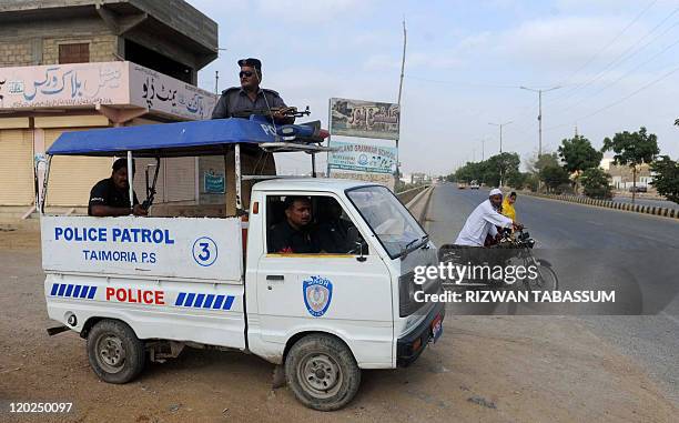 Pakistani policeman patrol in a police van in the troubled area of Karachi on August 2, 2011. At least 35 people were killed in 24 hours in Karachi,...