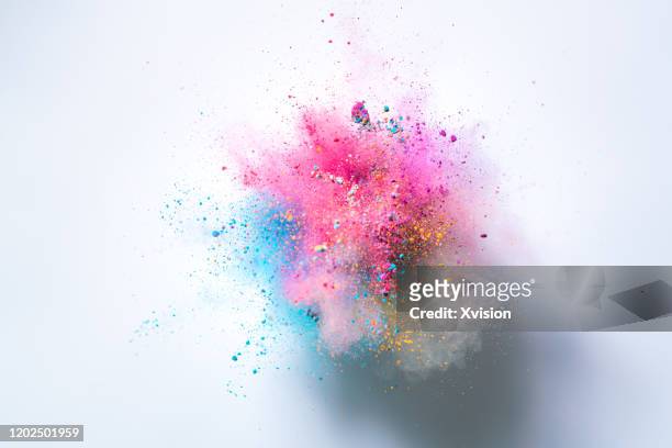 explode powder with white background captured with high speed sync. - esplodere foto e immagini stock