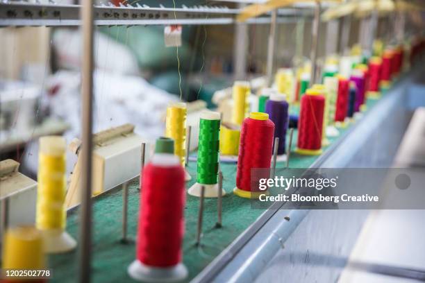 spools of cotton thread - garment factory stock pictures, royalty-free photos & images
